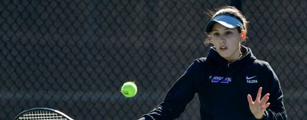 Knights women's tennis player hitting the ball during a game.